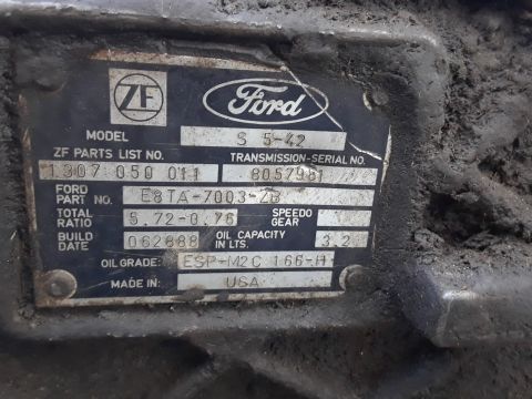 1996 Ford F-350 - A metal data plate on a transmission shows Ford and ZF logos, model, and serial numbers.