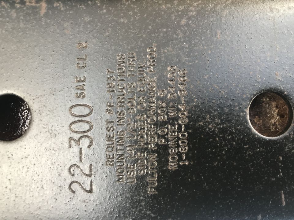 Metal part with stamped text '22-300 SAE CL 2', mounting instructions, and manufacturer info