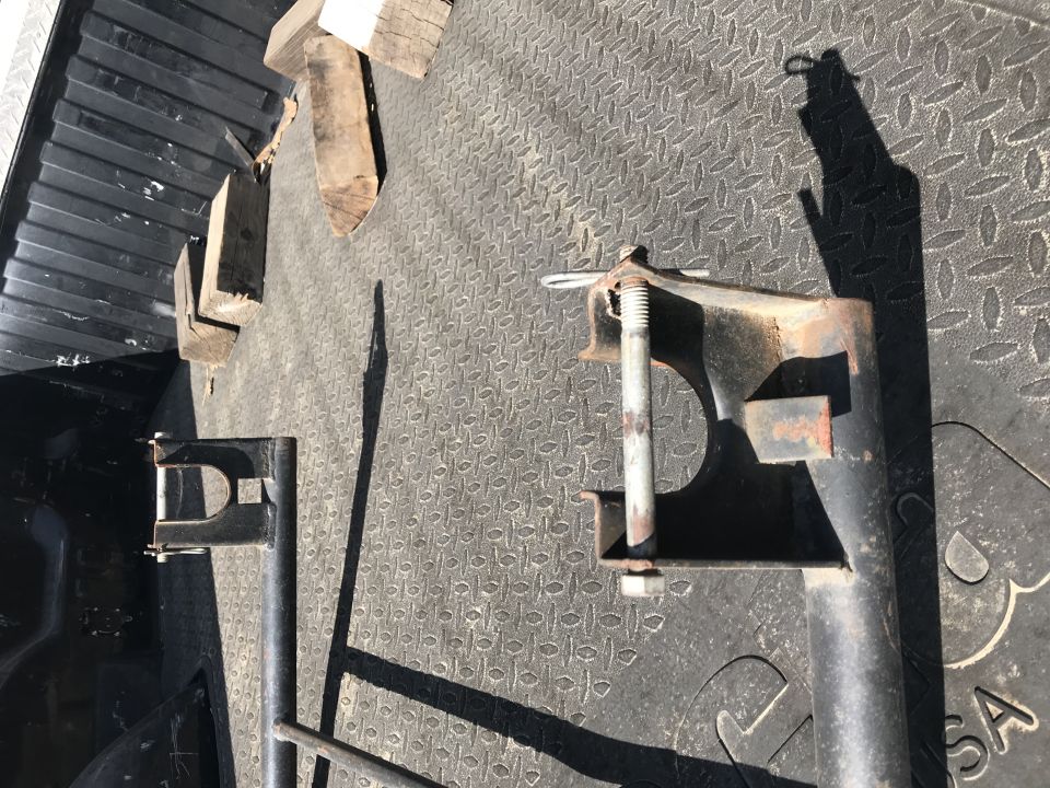 Metal brackets and wooden blocks on a textured truck bed surface
