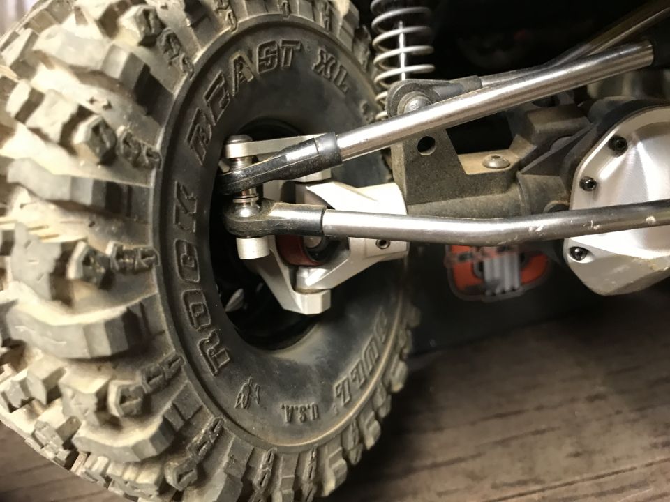 RC vehicle tire and suspension with "BEAST XL" text on sidewall.