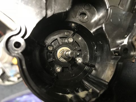 1989 Ford Bronco - The interior of a black plastic housing shows a central metal shaft surrounded by a circular component with several screws. The housing has…