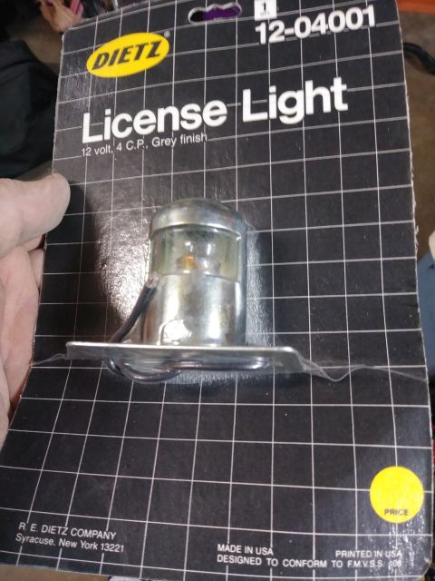 1996 Ford Bronco - A DIETZ license light part in its original packaging. The packaging indicates it is a 12 volt, 4 C.P. light with a grey finish and part num…