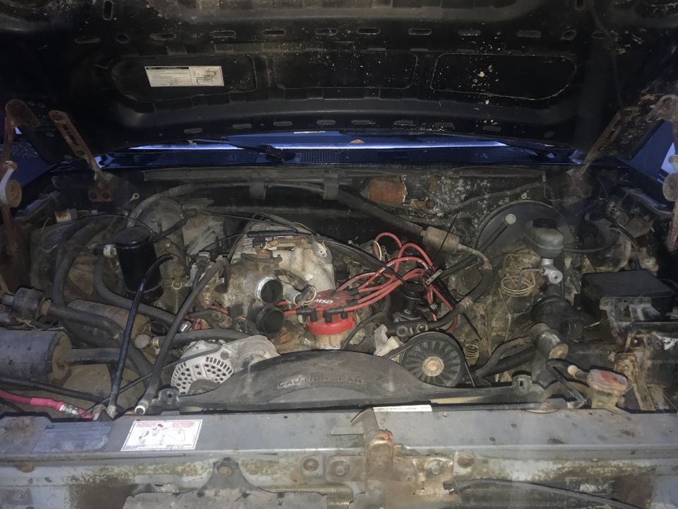 Engine bay of a 1992 Ford Bronco, showing engine components, wiring, and distributor.