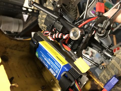 1989 Ford Bronco - A close-up view shows the battery and wiring installed in a vehicle. The battery is blue and yellow with text indicating it is a 3S 11.1V 1…