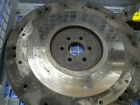 1985 Ford Bronco - A metal flywheel, likely for an engine rebuild, is shown in a close-up view.