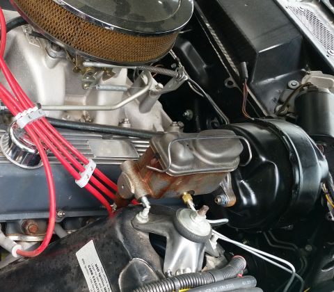 1971 Ford Ranchero - Close-up view of the engine bay of a classic vehicle, showing a chrome air cleaner assembly, red spark plug wires, and a brake master cylin…