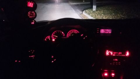 2000 Pontiac Grand Prix interior at night, showing glowing red gauges and radio display