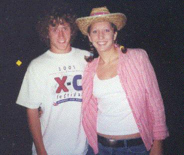 2003 Ford Bronco - A young couple poses for a photo at an outdoor event.