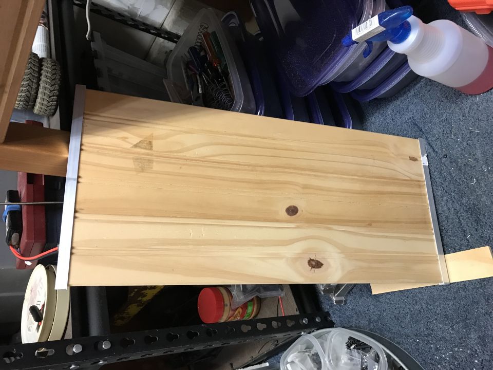 Wooden shelf with metal trim on a shelf unit.