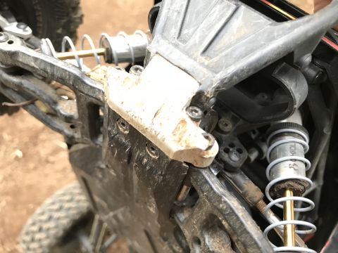 1989 Ford Bronco - Detail of a remote control car's chassis, showing suspension parts and accumulated dirt.