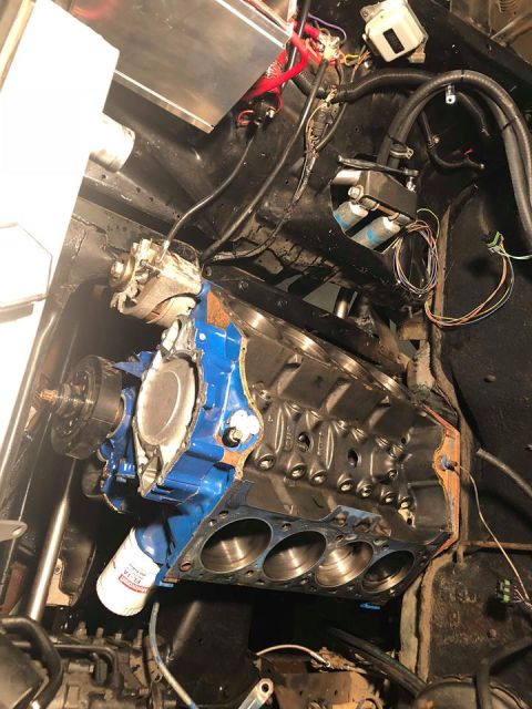 1979 Ford Bronco - Close-up view of an engine block and its associated components, including an oil filter and alternator.