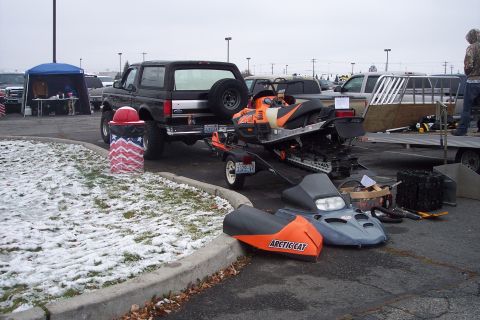 1995 Ford Bronco - A black 1995 Ford Bronco is seen towing a snowmobile and trailer in a parking lot with snow on the ground.