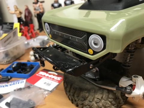 1989 Ford Bronco - RC car front end detail, showing grille and bumper assembly. Parts are scattered around.