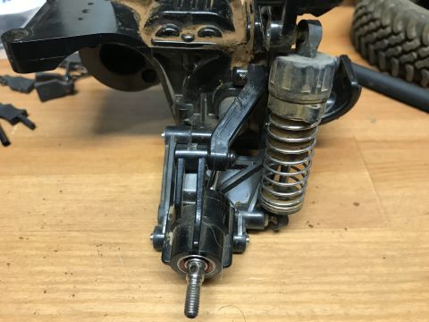 1989 Ford Bronco - This image shows a close-up view of a vehicle's suspension component, including a shock absorber and spring assembly.