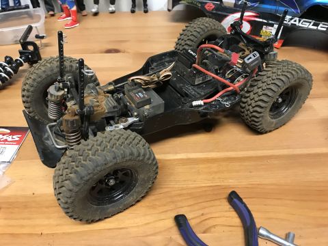 1989 Ford Bronco - A close-up view of a remote control car chassis, showing its mechanical components and off-road tires.