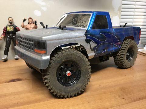 1989 Ford Bronco - This remote-controlled truck features a custom paint job and is displayed with action figures.