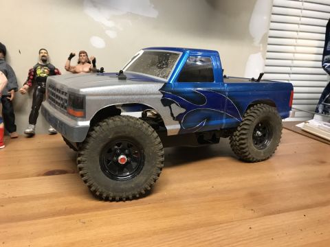 1989 Ford Bronco - This remote-controlled truck features a two-tone paint job with flame graphics and off-road tires.