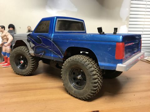 1989 Ford Bronco - RC truck model with custom flame decals and off-road tires.