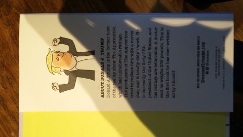 Back cover of a book with a cartoon of Donald Trump and descriptive text.
