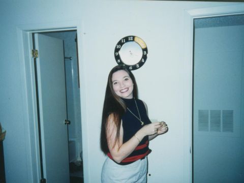 1993 Ford Bronco - A woman smiles for the camera in an indoor setting, with a clock visible on the wall behind her.