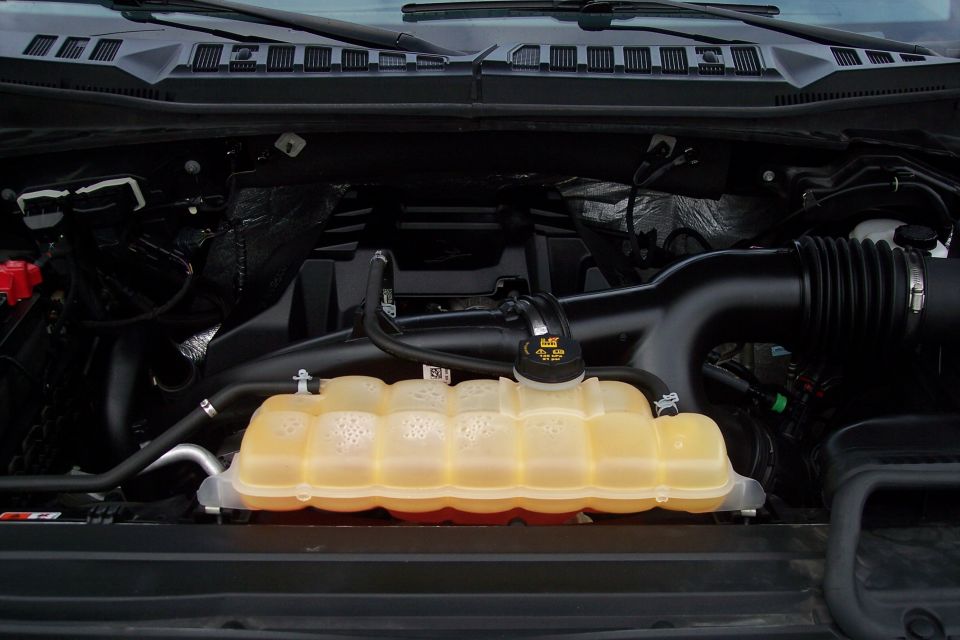 2015 Ford F-150 engine bay with coolant reservoir and air intake