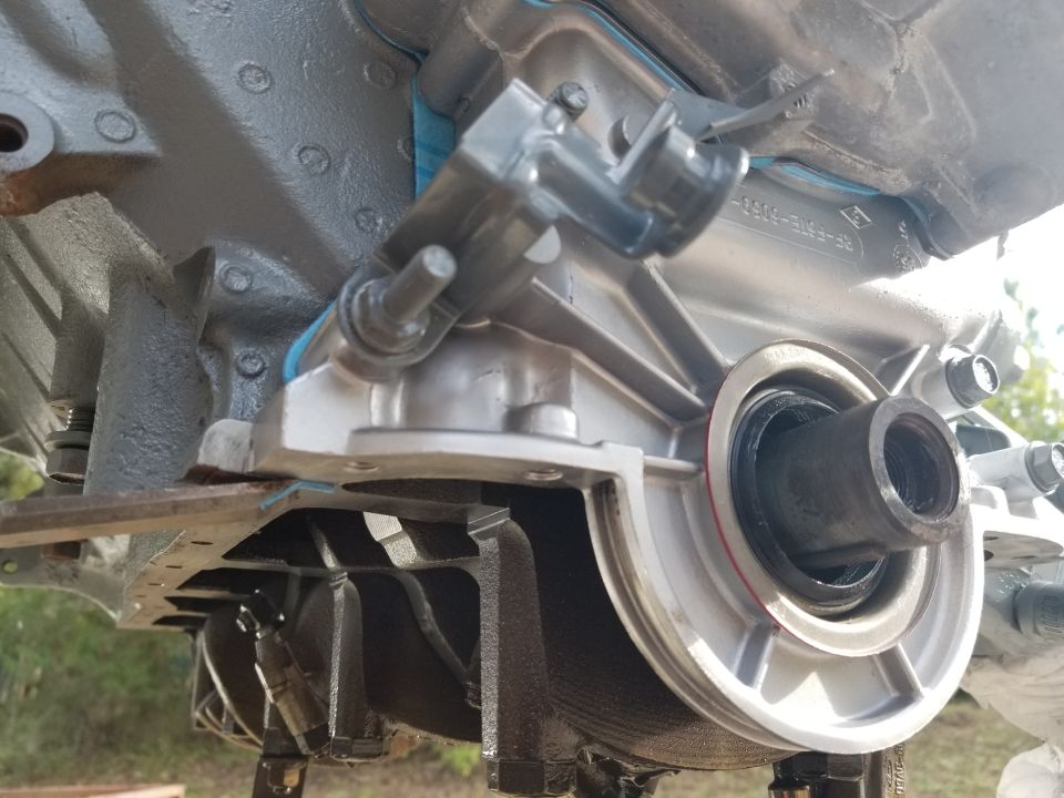 Close-up of a transmission housing with a seal and mounting bracket