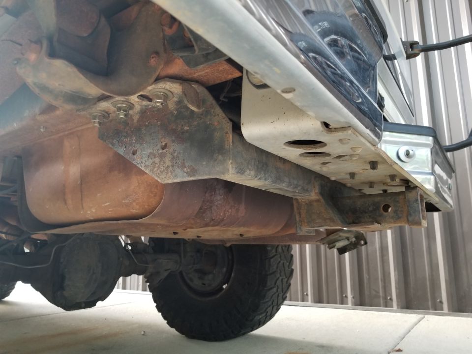 Underside view of a truck showing the fuel tank, rear axle, suspension, and frame components