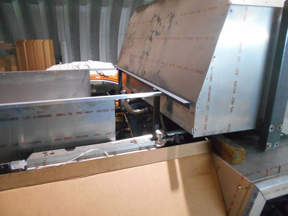 Close-up of aluminum panels with text markings in a workshop.