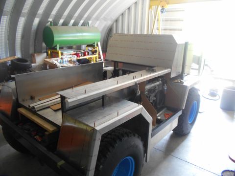 1992 Ford Bronco - A custom-built vehicle, possibly a buggy or off-road vehicle, is under construction in a workshop. The vehicle features a metal body, large…