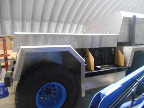 1992 Ford Bronco - A partially constructed vehicle with exposed metal body panels and a large tire is shown in what appears to be a workshop or garage. The ve…