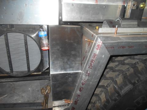 1992 Ford Bronco - A close-up view shows the front of a vehicle's engine bay, featuring a large radiator and a metal frame with visible text markings. A plast…