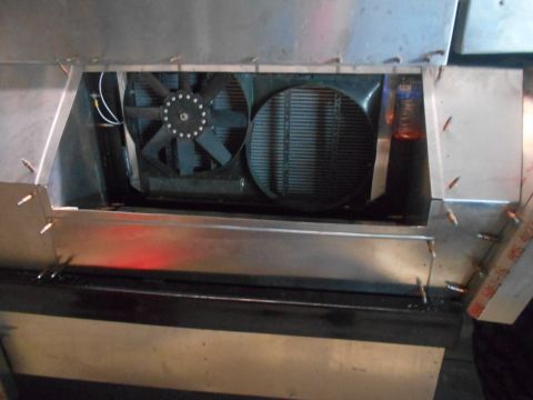 1992 Ford Bronco - A close-up view of a vehicle's cooling system, featuring two fans and a radiator, housed within a custom metal enclosure. The enclosure app…