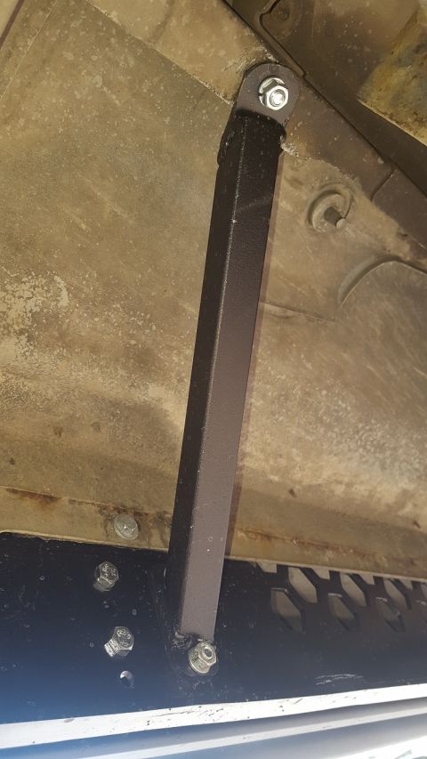 1995 Ford Bronco - Close-up view of aftermarket underbody bracing installed on a vehicle.