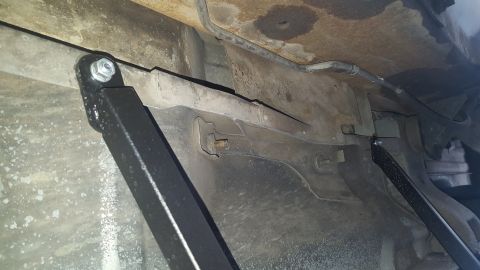 1995 Ford Bronco - Close-up view of the undercarriage, highlighting newly installed brackets and frame components.