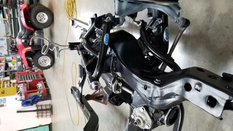 1970 Chevrolet Camaro - Close-up of vehicle suspension and frame components, with a red ATV in the background.