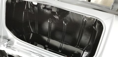 1970 Chevrolet Camaro - This photo shows the inside of a car's trunk, with a black painted ribbed metal floor.