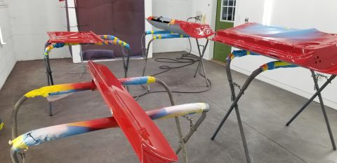 1970 Chevrolet Camaro - Car body panels are set up on stands for painting in a workshop environment.