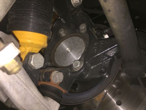 2015 Subaru Impreza - Detail of a vehicle's suspension system, showing a shock absorber and brake components.