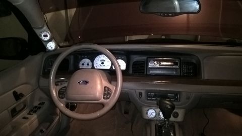2004 Ford Crown Victoria - Interior view of a 2004 Ford Crown Victoria, showing the dashboard, steering wheel, and added gauges.