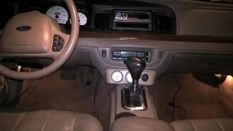 2004 Ford Crown Victoria - Interior view of a 2004 Ford Crown Victoria, the dashboard, steering wheel, and center console.