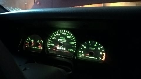 2004 Ford Crown Victoria - Illuminated dashboard gauges of a 2004 Ford Crown Victoria, showing the speedometer, tachometer, and fuel/temp gauges.