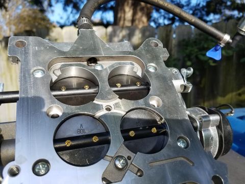 1977 Ford Ranchero - A carburetor part is shown with a hose attached, set against an outdoor background.