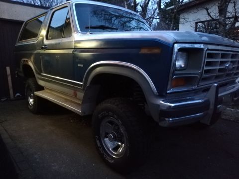 1996 Ford Bronco - This Ford Bronco features a distinctive two-tone paint scheme and prominent side steps.