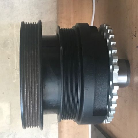 2000 Ford Explorer - A black crankshaft pulley with a timing gear is shown from the side.