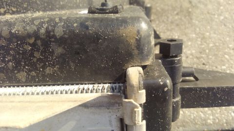 1990 Ford F-250 - the lip of the side tank connections it pretty big. in order to get it to sit against the fins, i used an angle grinder to trim the edges