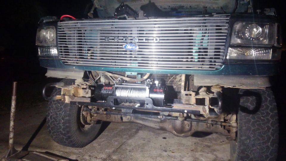 i welded 6 inch pieced of L steel to the front of the frame this gave me a good strong way to mount the winch in the front. i drilled 2 1/2 inch bolts on each side. i did trim some of the very front frame rails in order to get a flat surface to weld to