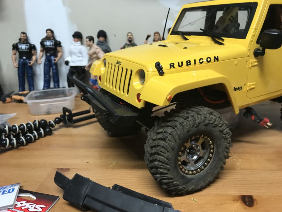 Yellow Jeep Rubicon model with large tires and aftermarket bumper
