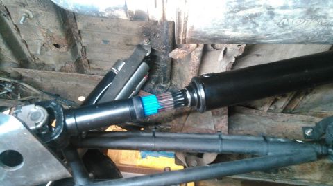 1978 Ford Bronco - Underside view of a vehicle's driveshaft and universal joint connection.