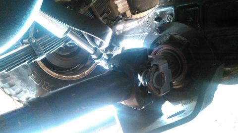 1978 Ford Bronco - Close-up view of the drive shaft and suspension system of an unidentified vehicle.