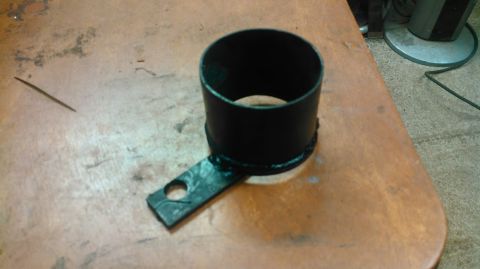 1978 Ford Bronco - A black metal part, possibly a drive shaft component, rests on a wooden surface. The registry claims it's from a 1978 Ford Bronco, but this…